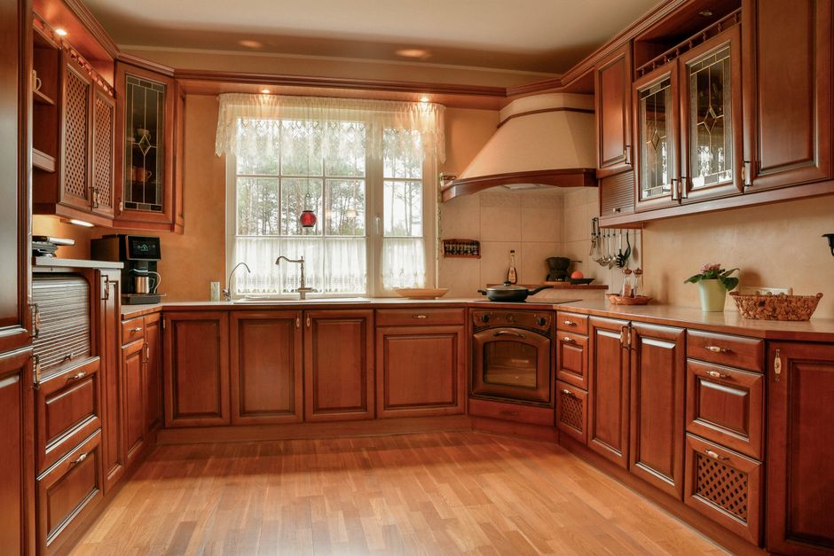 Warm traditional kitchen with wooden cabinets and a tiled floor.