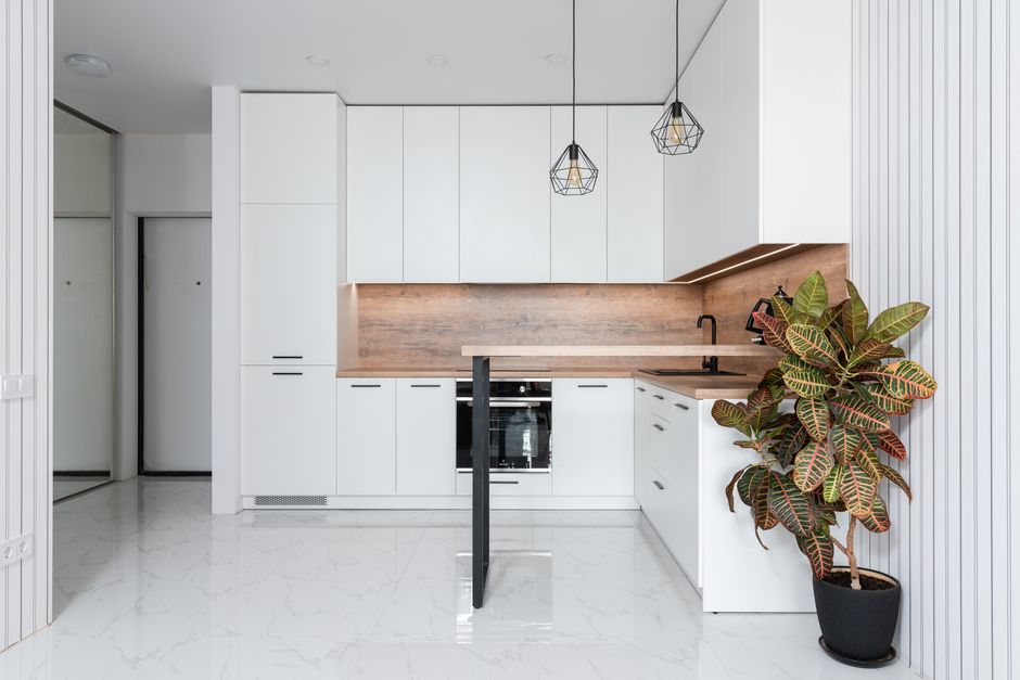 Light kitchen with white cabinets and modern appliances.